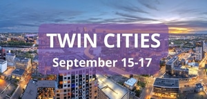 Aerial view of downtown Minneapolis at sunset with vibrant city lights, overlaid with text “Twin Cities, September 15–17
